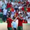 Jogador de futebol Cancelo a festejar um golo num jogo de Portugal